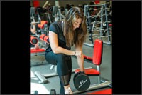 Student lifting weights with Rec Sports